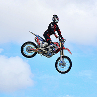 Person on motorcycle performing stunts